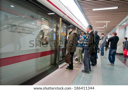 SHANGHAI, CHINA - MARCH 20: Chinese pepole waits for a train in People\'s Square Metro Station - interchange between Lines 1, 2 and 8 on March 20, 2013 in Shanghai