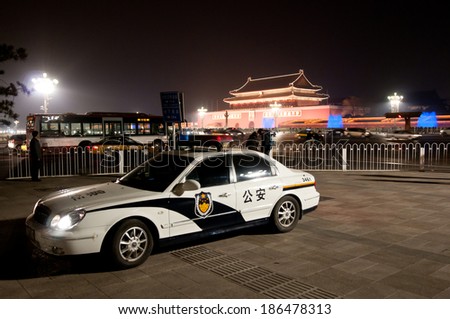 BEIJING, CHINA - MARCH 28: Police car near Tiananmen Square, with Gate of Heavenly Peace (Tiananmen) on background on March 28, 2013 in Beijing