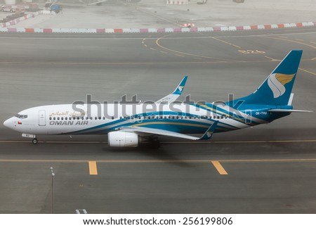 DUBAI - FEBRUARY 21: An Oman Air plane is taxiing to the gate after arrival in a heavy sand storm in Dubai as seen on February 21, 2015.