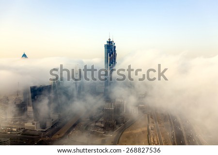 Buildings are covered in thick layer of fog in Dubai downtown.