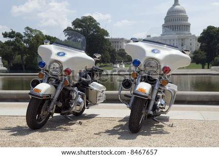Two Secret Service motorcycles parked in front of The Capitol in Washington, DC.
