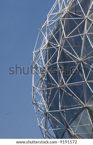 A detail of a geodesic dome, invented by Richard Buckminster Fuller, against a blue sky.