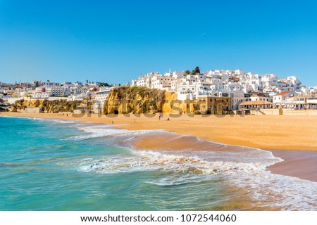Similar – Image, Stock Photo Wide sandy Faro beach with dunes and walkways by the sunset, Algarve, Portugal
