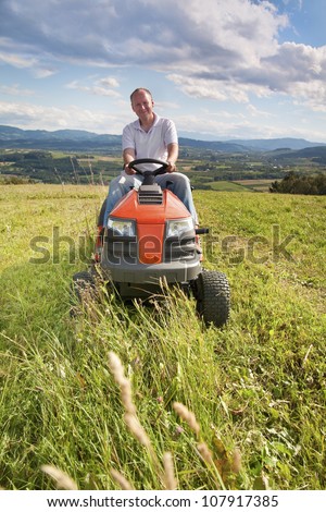 Man mowing his lawn on a riding lawn mower