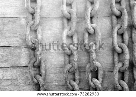 Old chain on wooden background in black and white