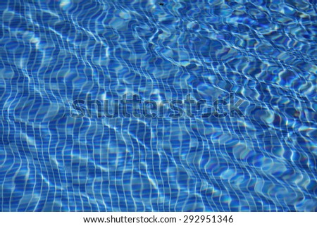 Beautiful azure turquoise colored clear transparent pool water out of focus