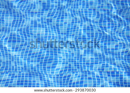 Beautiful azure turquoise colored clear transparent pool water out of focus. Sun reflected in the swimming pool water as a background