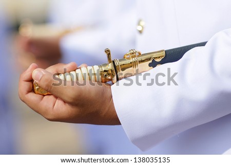 Left hand holding Military Officer\'s Sword