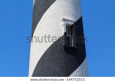 A segment of a black and white light house in Florida, USA