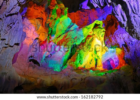 Beautiful illuminated multicolored stalactites from karst Reed Flute cave. Guilin Guangxi. China