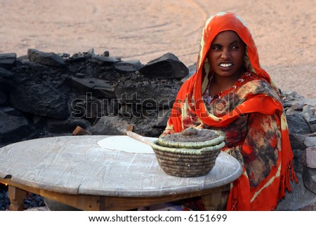 The woman - Bedouin  makes  traditional flat cakes of a flour . Marsa Alam. Egypt