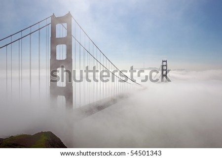Golden Gate Bridge is shown in a fog by the shined sunlight , San Francisco, California