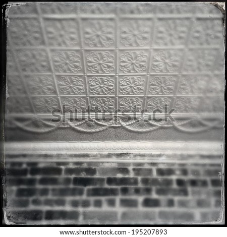 Instagram style image of an old tin ceiling tiles and brick wall