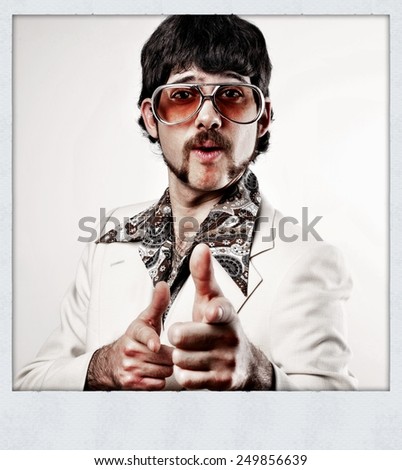 Instagram filtered image of a Retro 1970s man in a leisure suit pointing to the camera - instant film style photo