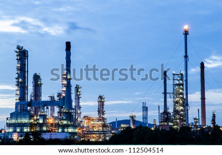 Petrochemical industry on sunset dark blue sky.