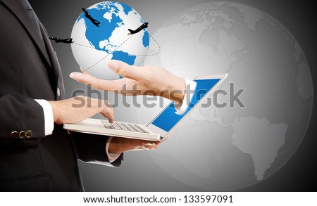 Businessman pushing on laptop keyboard for Business Concept with hand holding World Map Globe. with airplane around the globe.