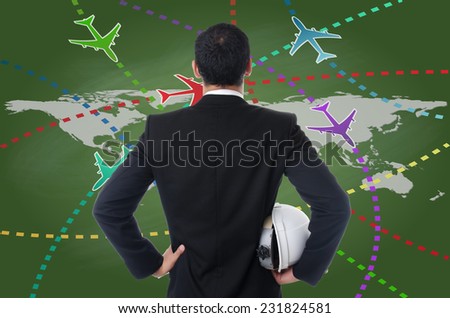 Businessman working with Airplane travel around the city on the blackboard.