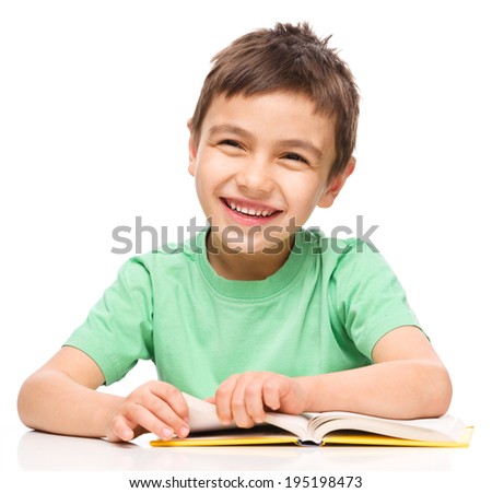 Cute little boy is reading a book, isolated over white