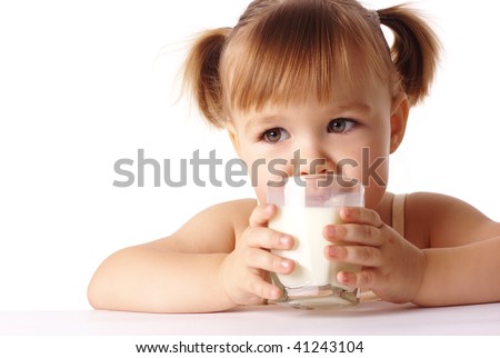 Cute little girl drinks milk, isolated over white