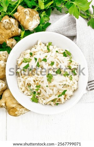 Similar – Image, Stock Photo Plate with raw Jerusalem artichoke on concrete kitchen table with olive oil, herbs and spices. Cooking preparation at home with root vegetable. Top view.