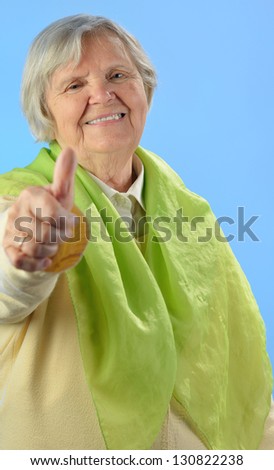 Senior happy woman with grey hairs against blue background. MANY OTHER PHOTOS FROM THIS SERIES IN MY PORTFOLIO.