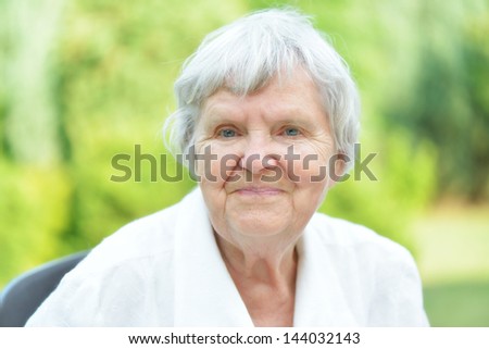 Senior woman in garden. MANY OTHER PHOTOS WITH THIS MODEL IN MY PORTFOLIO.