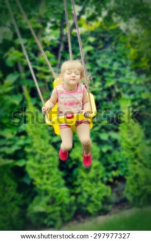 Cute little girl swings. Outdoors scenery. MANY OTHER PHOTOS FROM THIS SERIES IN MY PORTFOLIO.