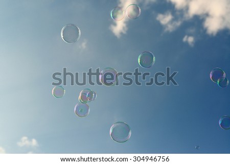 Soap bubbles on blue sky.