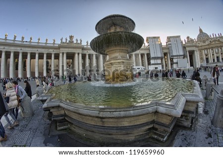 ROME - NOV 2: People enjoy St Peter Square, November 2, 2012 in Rome. The square was redesigned by Gian Lorenzo Bernini from 1656 to 1667 under the direction of Pope Alexander VII.