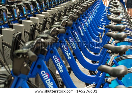 NEW YORK - JUN 9: Bicycles are shown docked at a Citibike sharing kiosk on June 9, 2013 in New York. Operated by NYC Bike Share, thousands of bikes will be available for locals and tourists