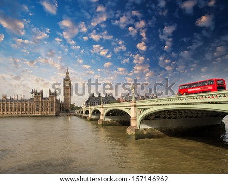 Westminster Bridge and Houses of Parliament at sunset, London. Beautiful view with red bus crossing the bridge.