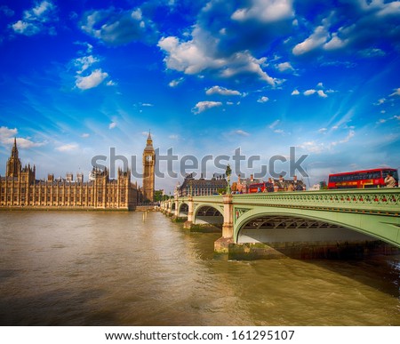 Classic Red Double Decker Buses crossing Westminster Bridge to the Houses of Parliament - London.