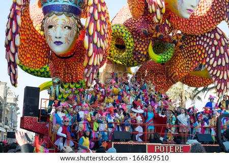 VIAREGGIO, ITALY - FEB 16: Festival, the parade of carnival floats with dancing people on streets of Viareggio, February 16, 2013 in Viareggio,Italy.