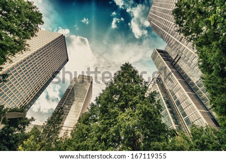 London, Canary Wharf. Beautiful view of Skyscrapers and trees from street level.
