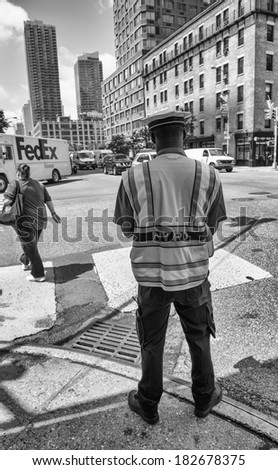 NEW YORK CITY - JUNE 14, 2013 : NYPD Police officer checks the traffic in NYC. The New York City Police Department (NYPD),established in 1845 is the largest municipal police force in the United States