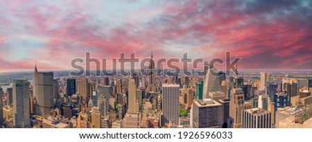 Midtown Manhattan at sunset, New York City. Panoramic aerial view of city skyscrapers at dusk.