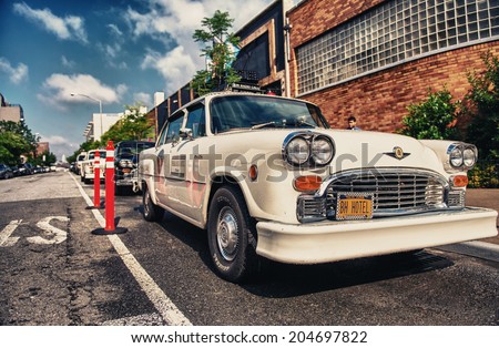 BROOKLYN, NY - JUN 11, 2013: Vintage white taxi cabs await customers. Today, more than 13,000 modern taxis take the place of the old ones