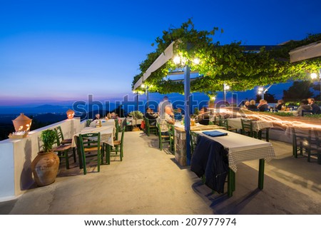 KOS, GREECE - JUNE 6, 2014: Restaurant view at night in Zia village. Zia has the most beautiful sunset view of the island and is a famous attraction among tourists.