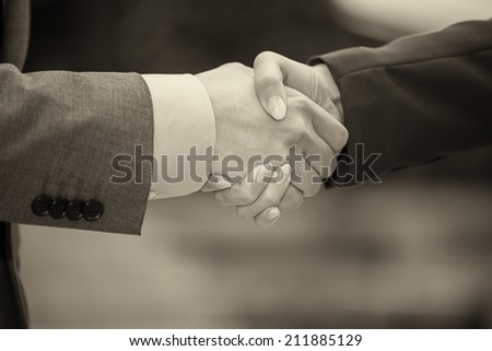 Business handshaking outdoor.