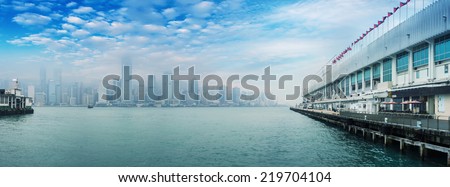HONG KONG - MAY 12, 2014: Stunning panoramic view of Hong Kong Island from Kowloon port on a cloudy day. Last year HK hosted more than 54 million visitors, most of them from the mainland.