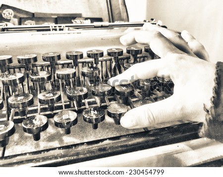 Baby hand typing on a old typewriter.