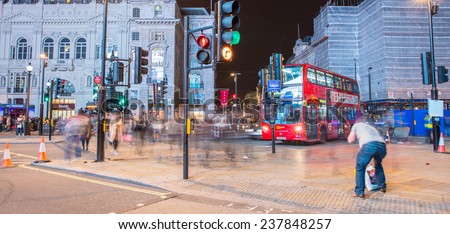 LONDON - SEPTEMBER 27, 2013: Tourists in Piccadilly at night. More than 30 million people visit London every year.