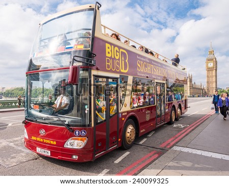 LONDON - SEPTEMBER 29, 2013: Bus sightseeing tour in front of Big Ben. More than 30 nillion people visit London every year.