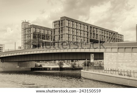 BERLIN - MAY 27, 2012: Tourists visit the modern buildings in Bundestag area along Spree river. The city has more than 26 million overnight stays every year.