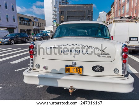 BROOKLYN - JUN 12, 2013: Vintage white taxi cabs await customers. Today, more than 13,000 modern taxis take the place of the old ones.