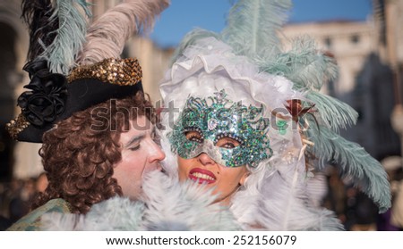 VENICE, ITALY - FEBRUARY 8, 2015: Unidentified masked couple in costume in St. Mark\'s Square during the Carnival of Venice 2015. The 2015 carnival started on January 31.