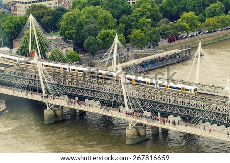 LONDON - SEPTEMBER 28, 2013: Underground train crosses bridge. London\'s system is the oldest underground railway in the world, dating back to 1863
