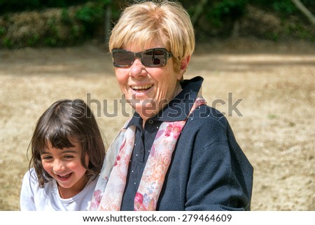 Grandmother and nephew enjoying outdoor life in a city park.