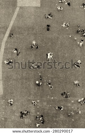 People relaxing in the park. Aerial view with all faces blurred.