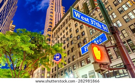 New York City street signs at night.